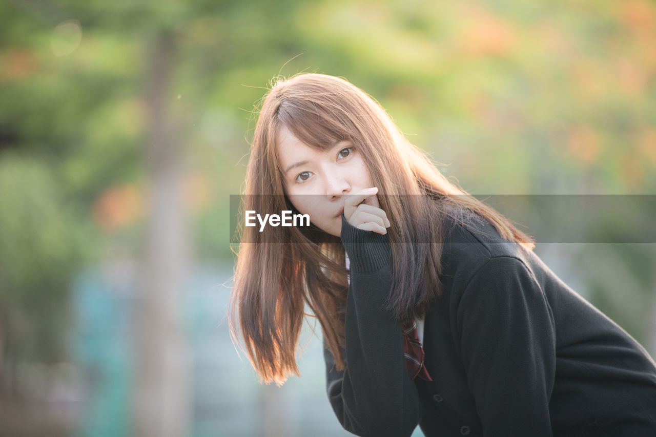 Portrait of young woman standing outdoors