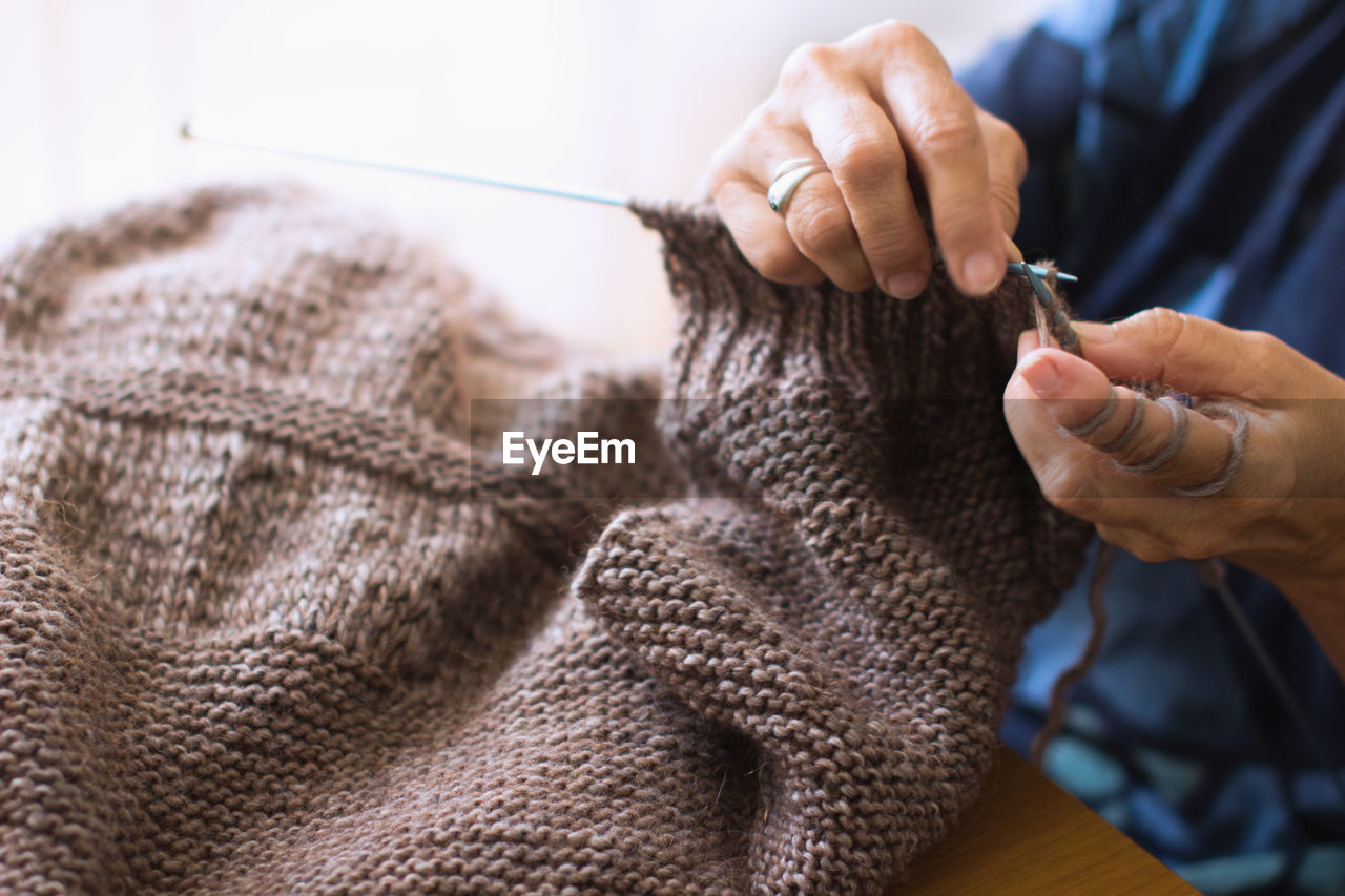 Cropped image of hands knitting wool