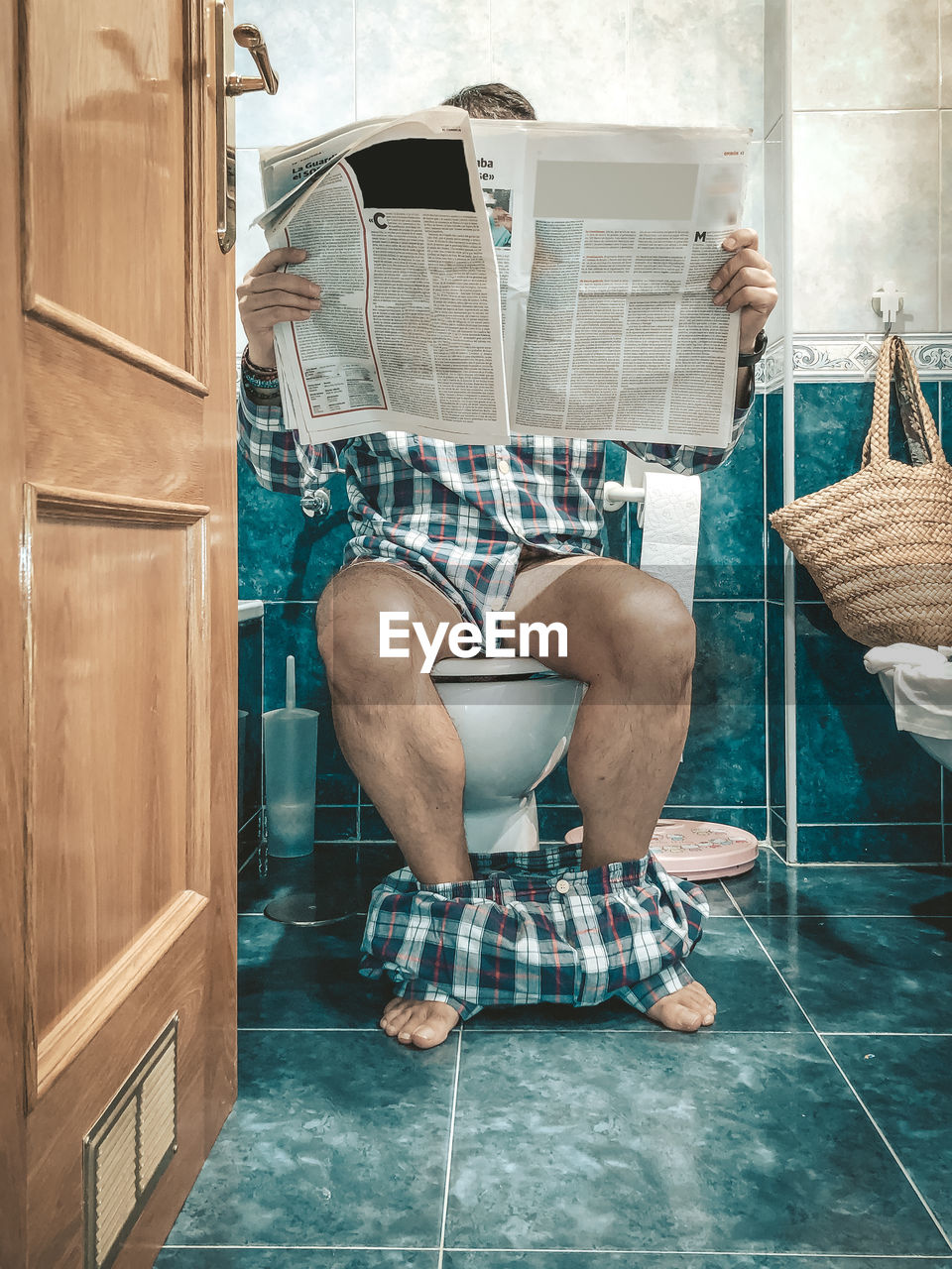 Low section of man sitting in bathroom