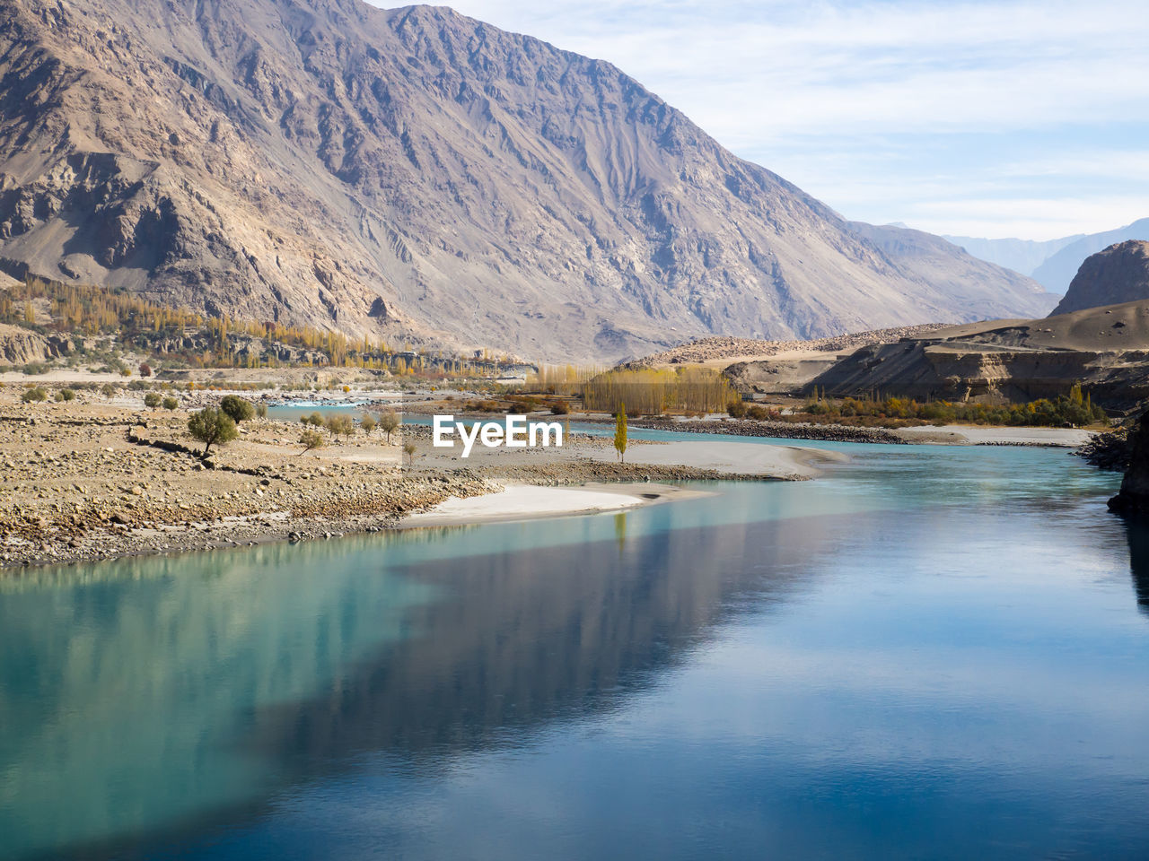 Scenic view of lake and mountains against sky