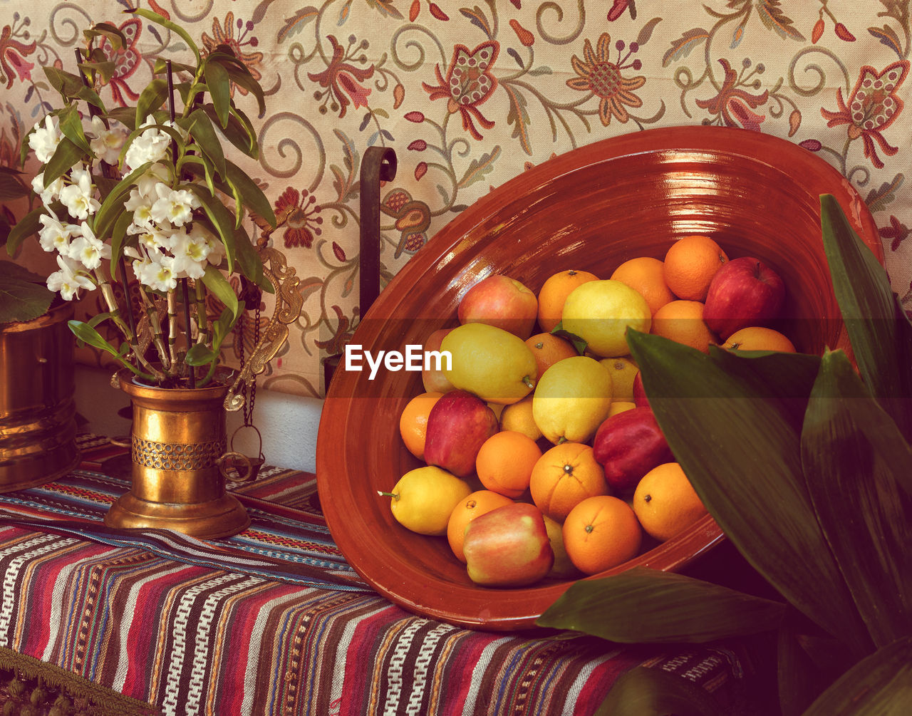 Fruits in a clay basket on table