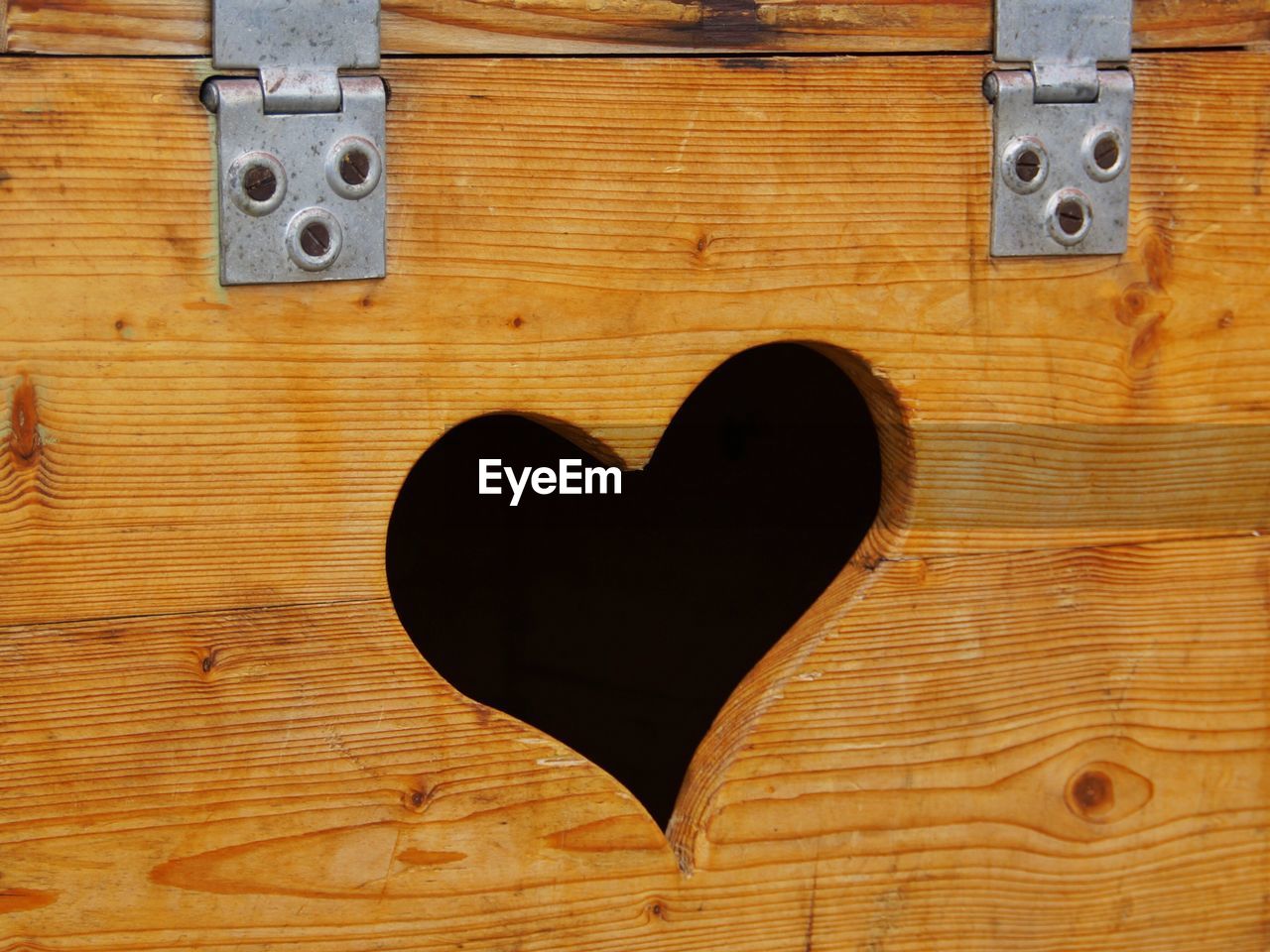 Close-up of heart shaped hole on wooden box