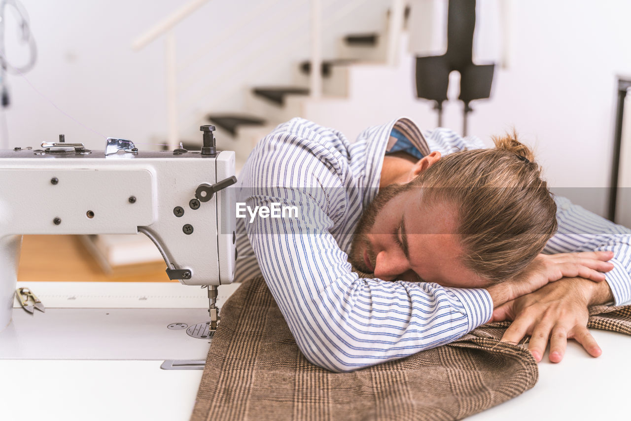 Male fashion designer resting at studio