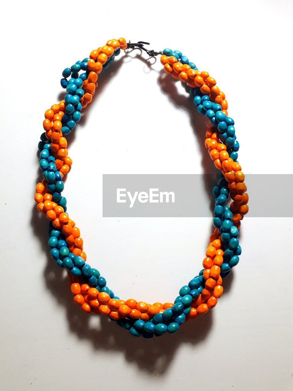 Directly above shot of necklace on white background