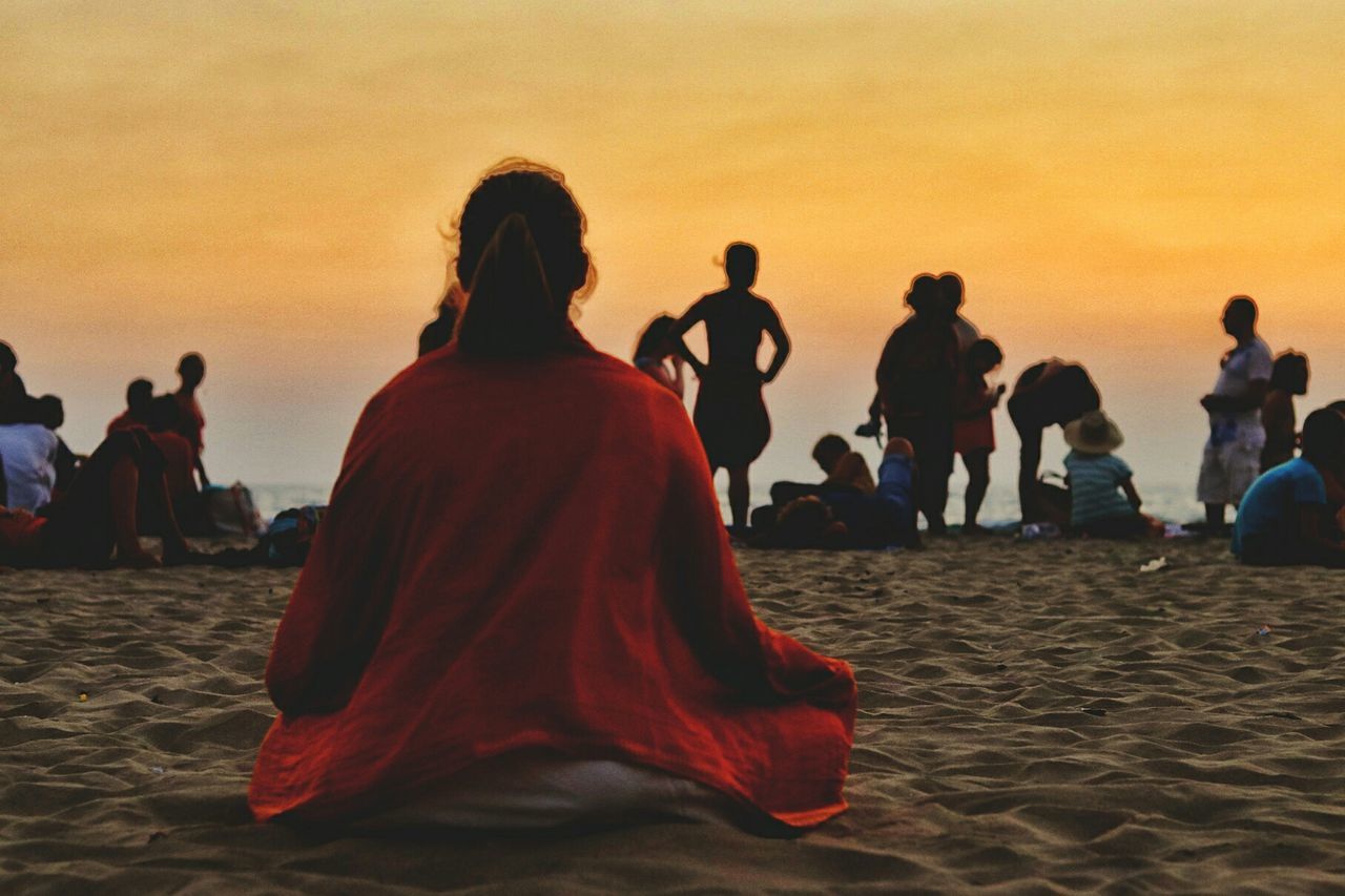 PEOPLE ON BEACH AT SUNSET