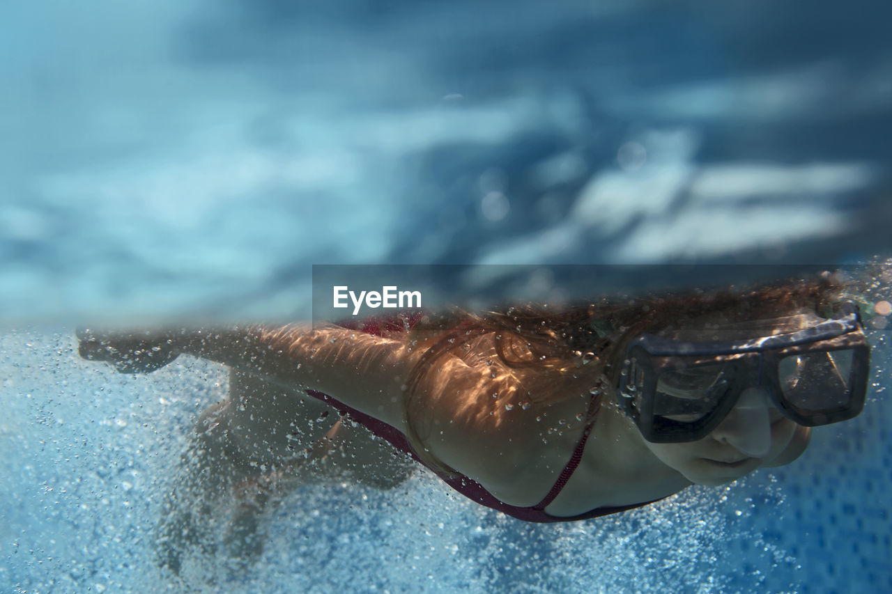 Close-up of girl swimming in pool