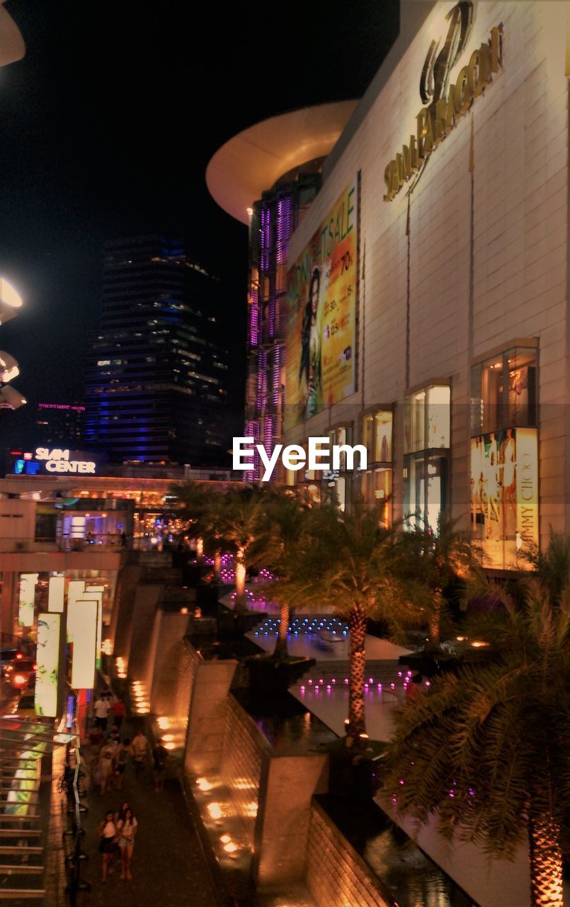 ILLUMINATED BUILDINGS IN CITY AT NIGHT