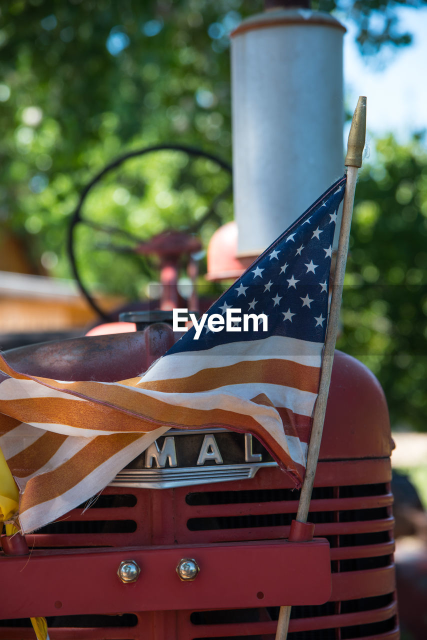 Close-up of american flag on tractor