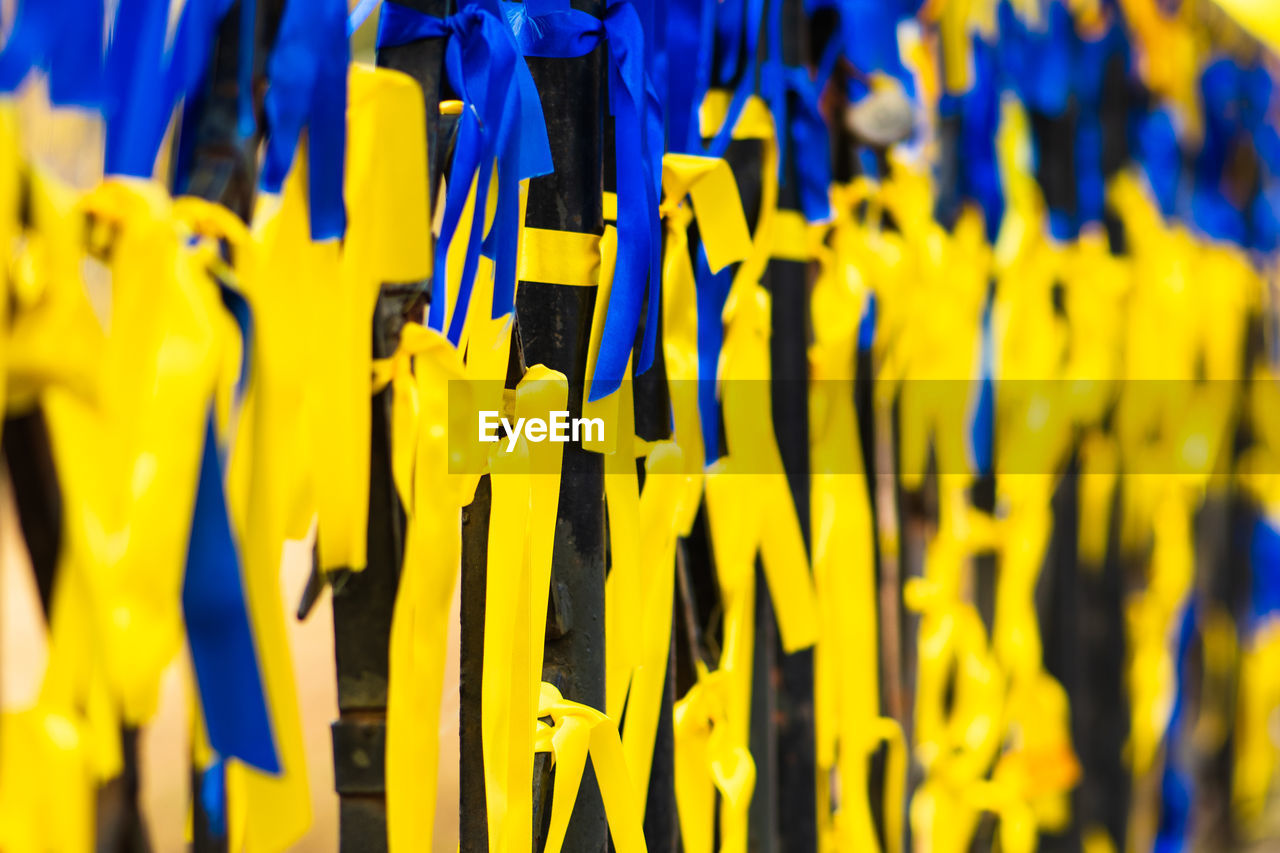 Ribbons with colors of ukraine during peaceful demonstration against war, ukrainian flag background