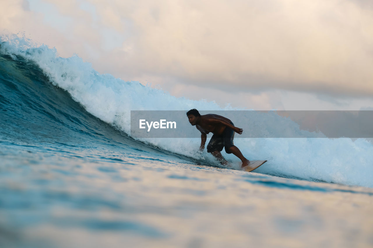 Surfer on a wave at day time