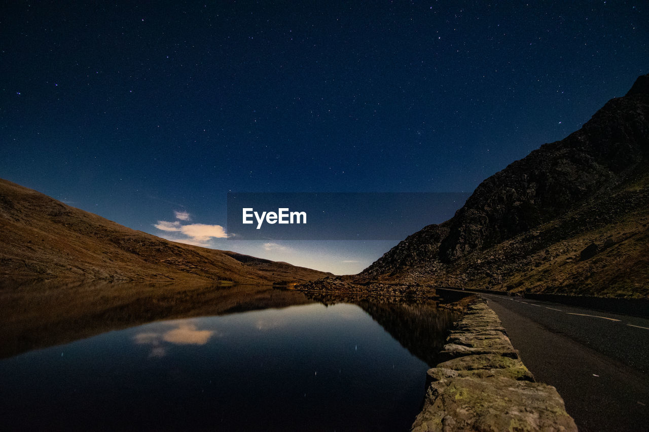 Scenic view of mountains against sky at night