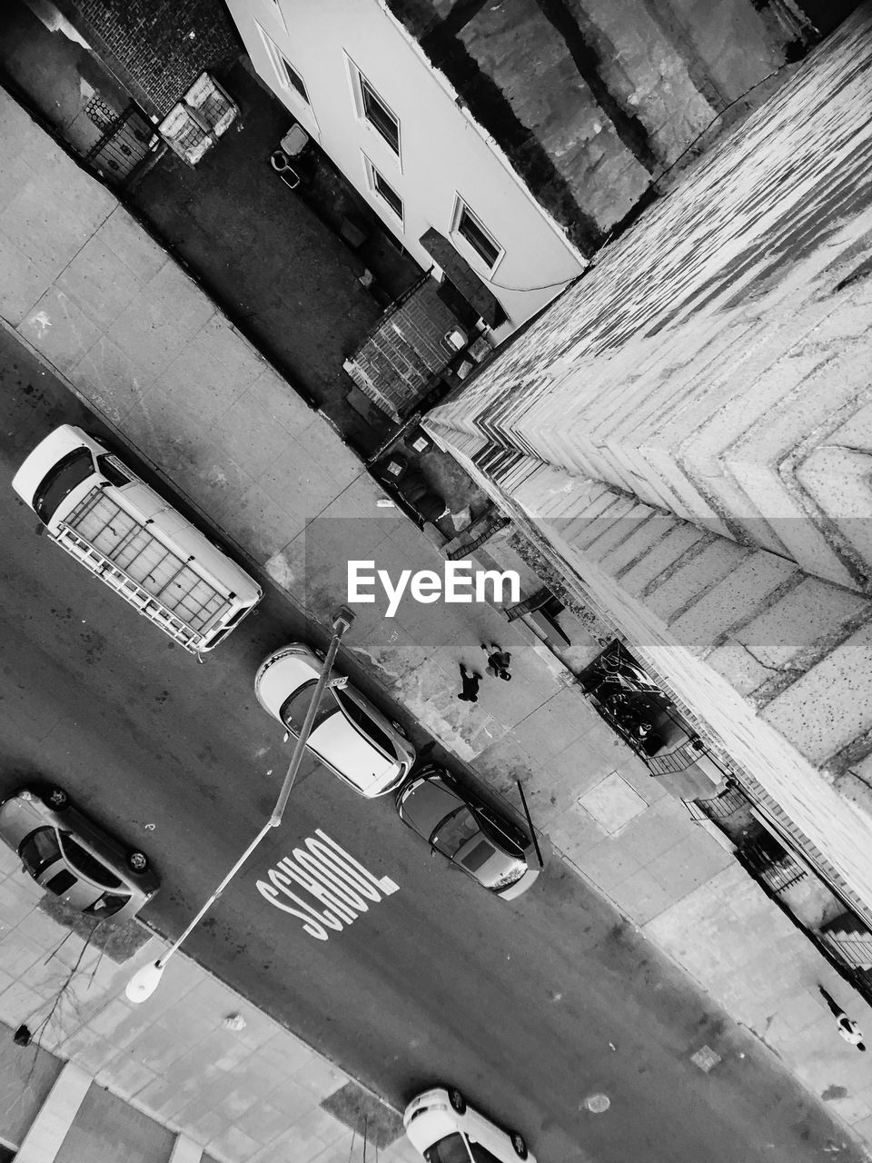 High angle view of vehicles on road along buildings