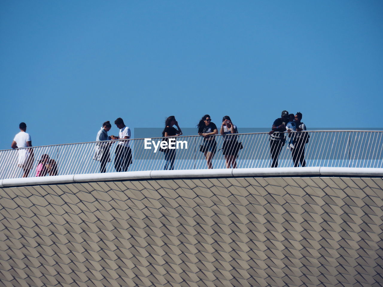 GROUP OF PEOPLE AGAINST CLEAR BLUE SKY