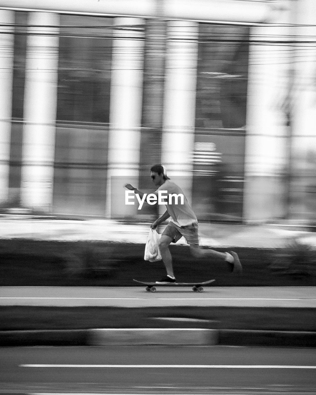 Blurred motion of man skateboarding on road