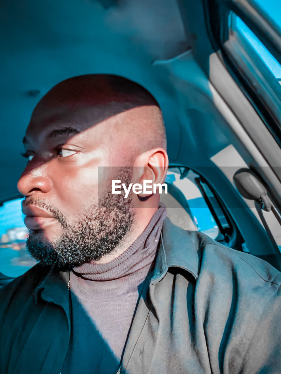 Portrait of young man in car