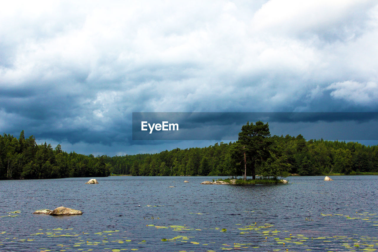 Scenic view of lake against cloudy sky