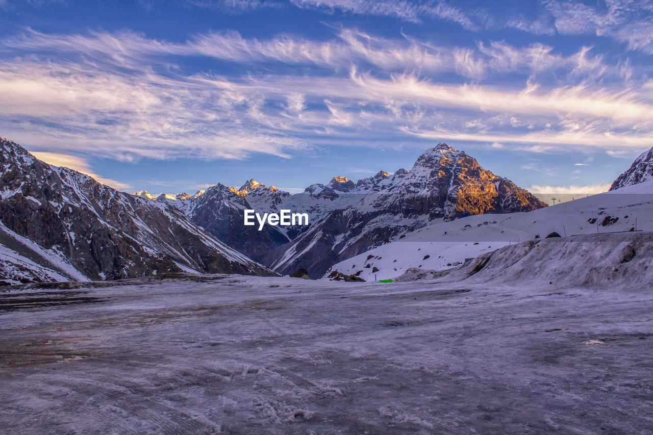 View of snowcapped mountain against cloudy sky