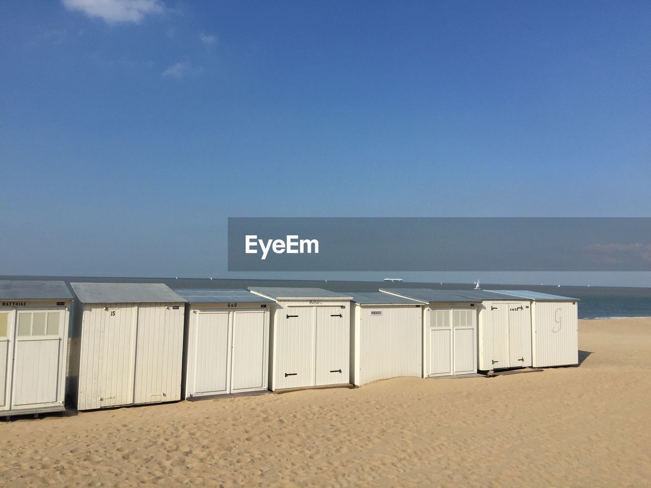 Scenic view of beach against clear blue sky