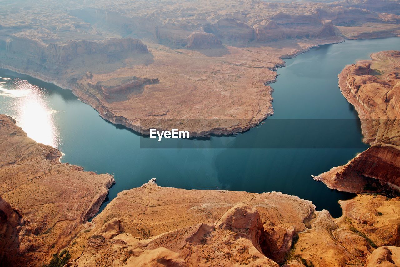 High angle view of rock formations by lake