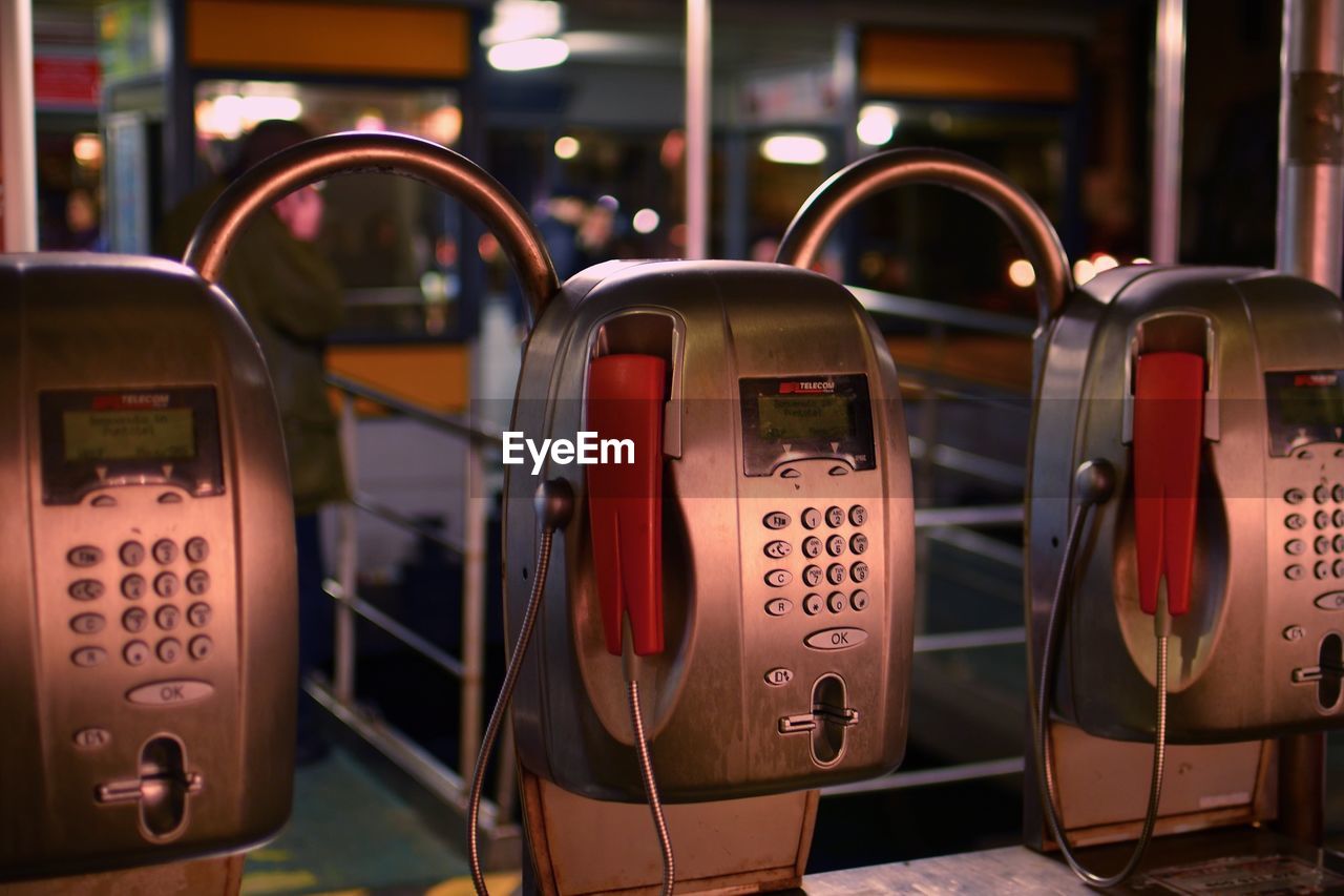 Close-up of pay phones in city at night