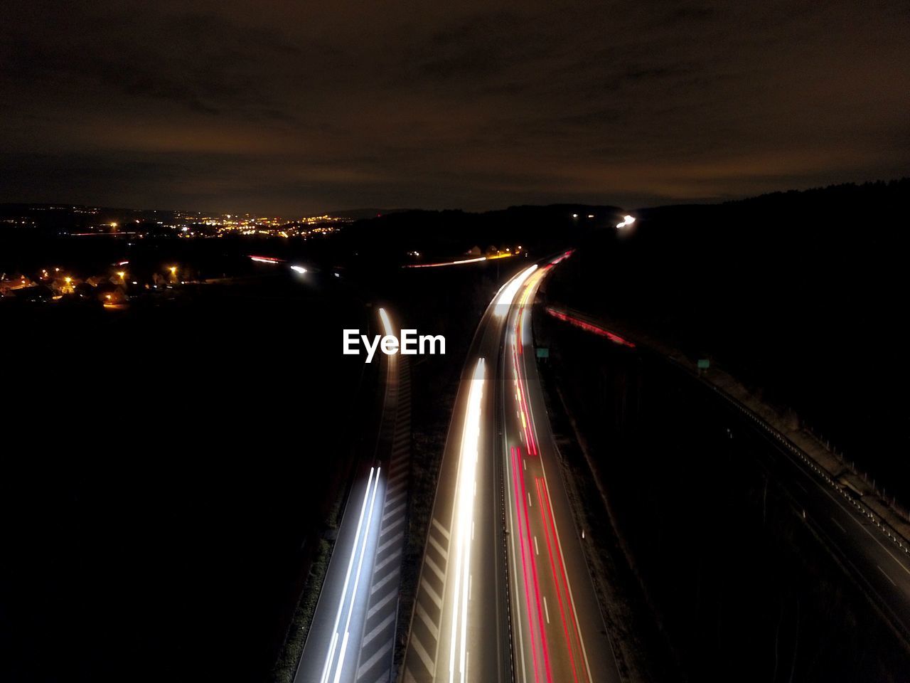 HIGH ANGLE VIEW OF LIGHT TRAILS ON ROAD IN CITY