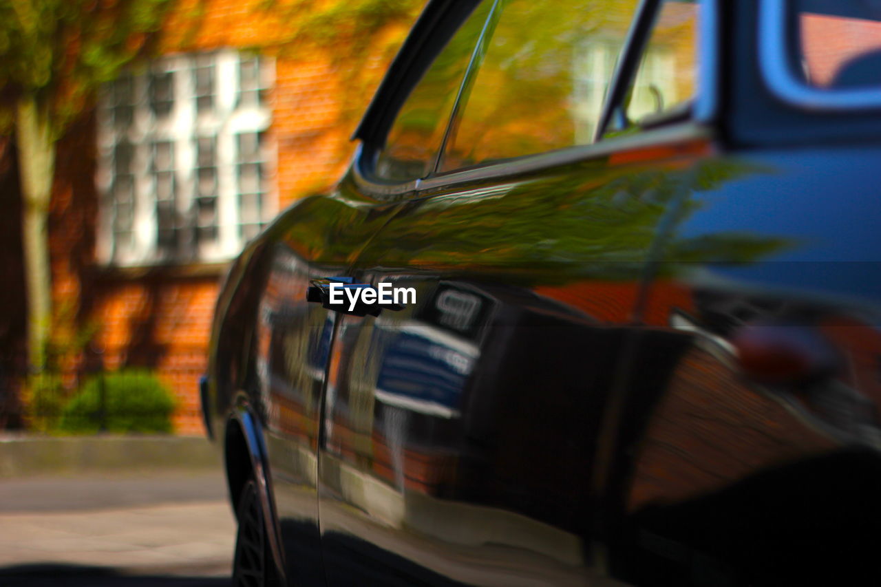 CLOSE-UP OF CAR ON ROAD