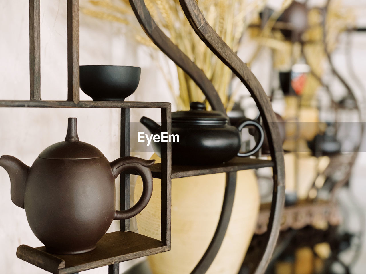 Close-up of teapot on shelf