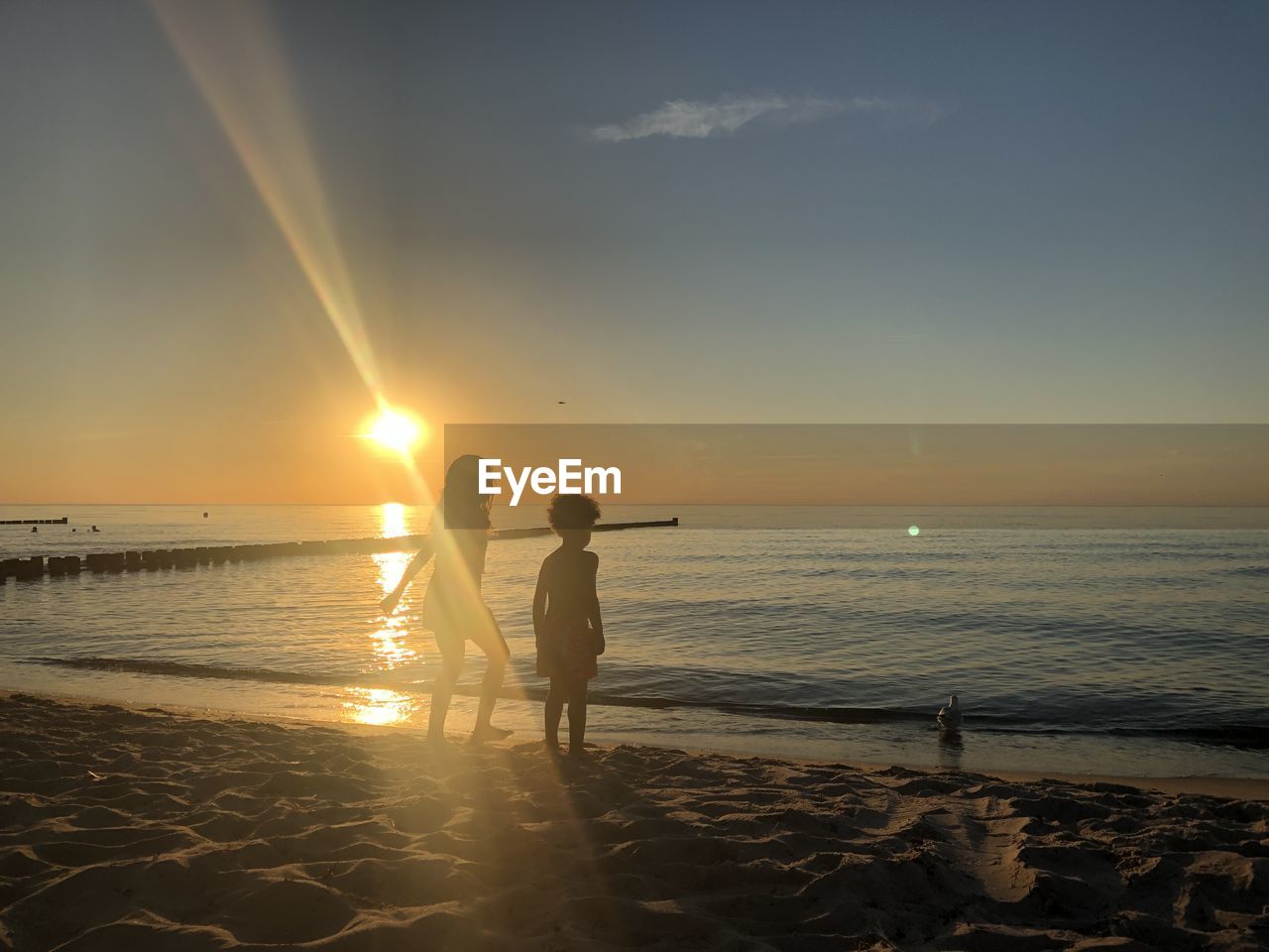 SILHOUETTE PEOPLE AT BEACH DURING SUNSET