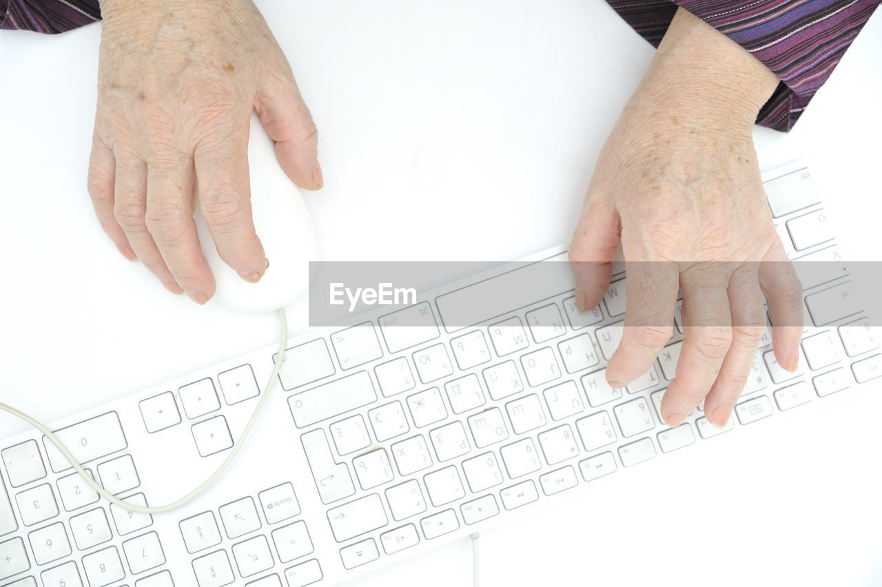 Cropped image of person typing on computer keyboard