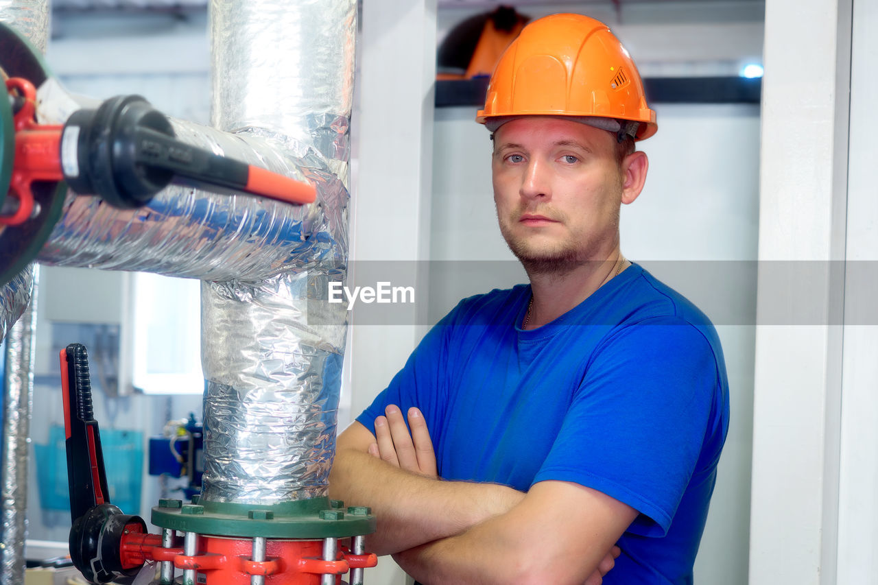 portrait of young man working in factory