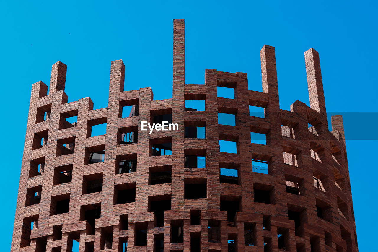 Low angle view of building against clear blue sky