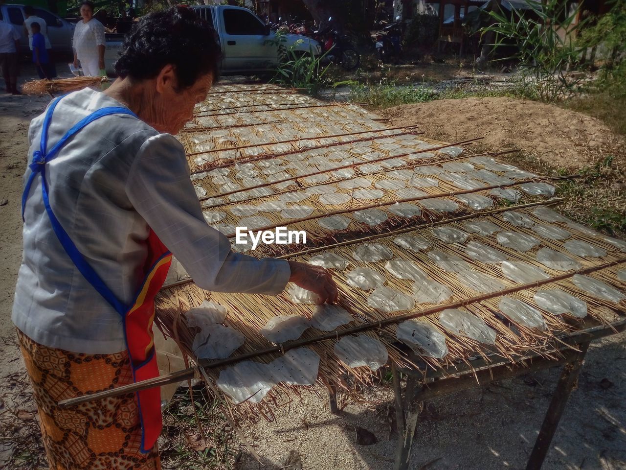 MAN WORKING ON GRILL