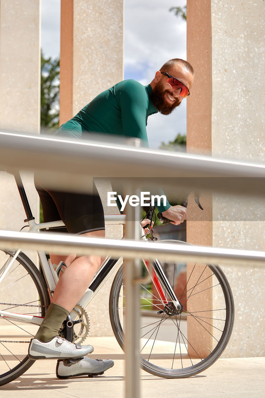 side view of young man with bicycle