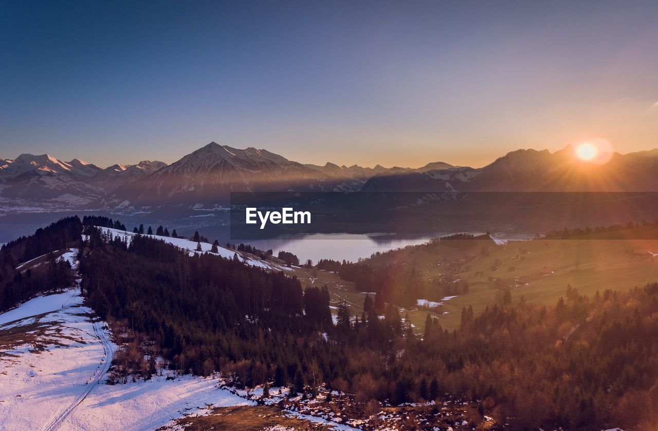 Scenic view of mountains against clear sky during winter