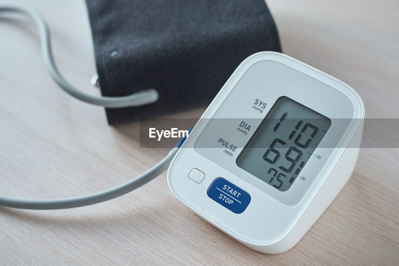 Digital blood pressure monitor on table, closeup. helathcare and medical concept