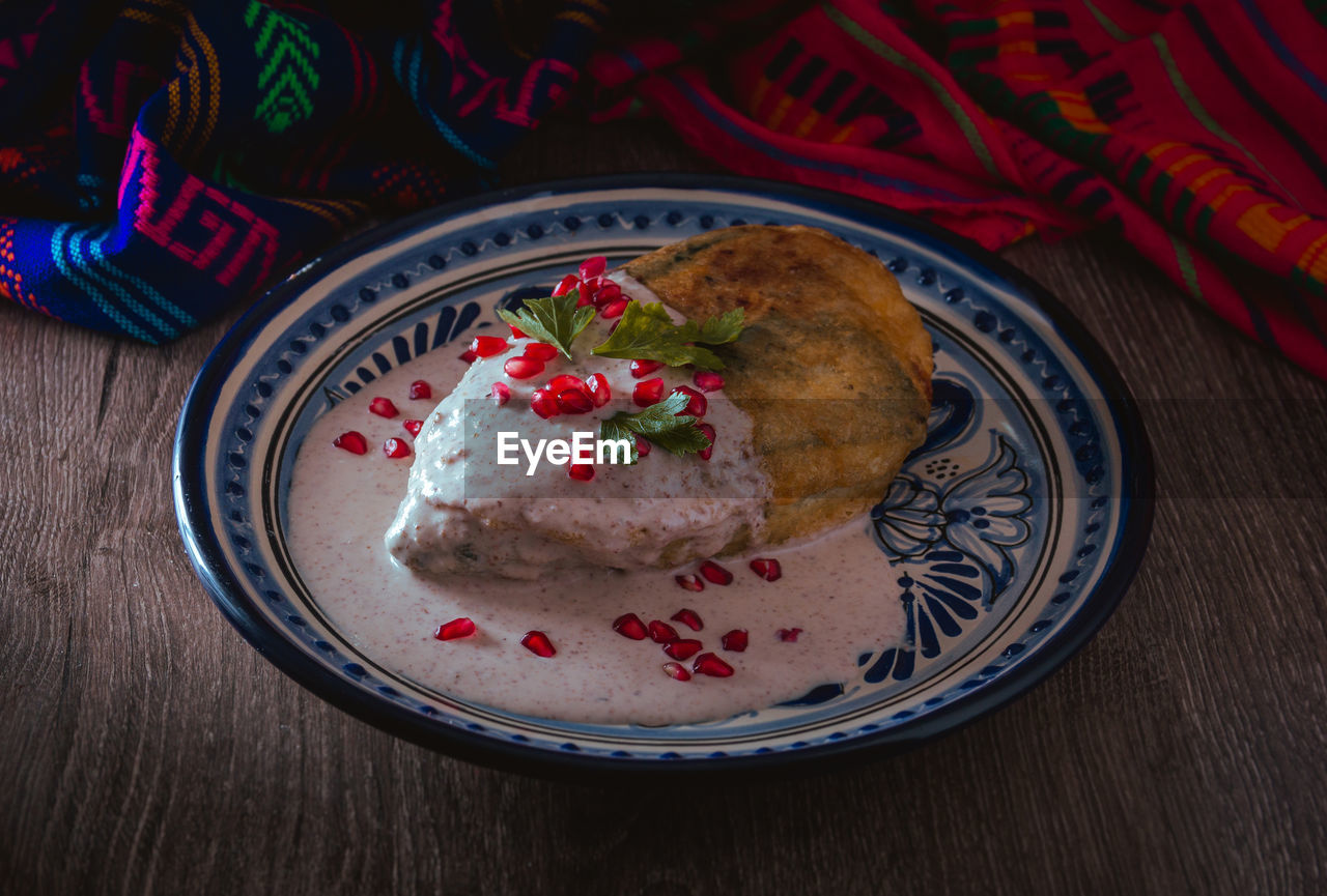 Chile en nogada on a talavera plate from puebla, traditional cuisine of mexico