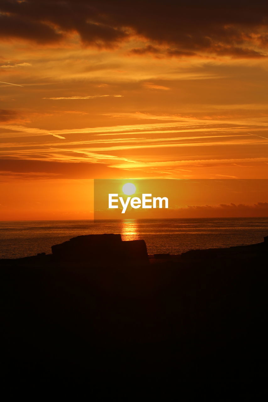 SCENIC VIEW OF SUNSET OVER BEACH