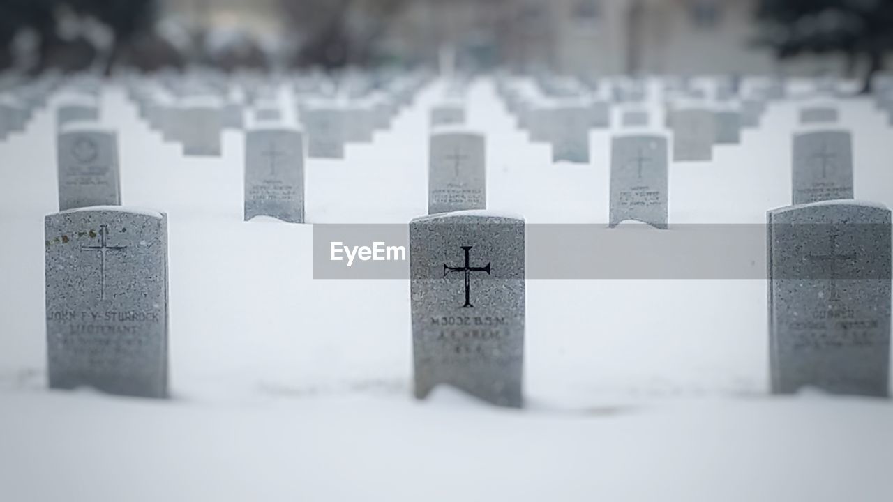 CLOSE-UP OF CEMETERY AGAINST SNOW