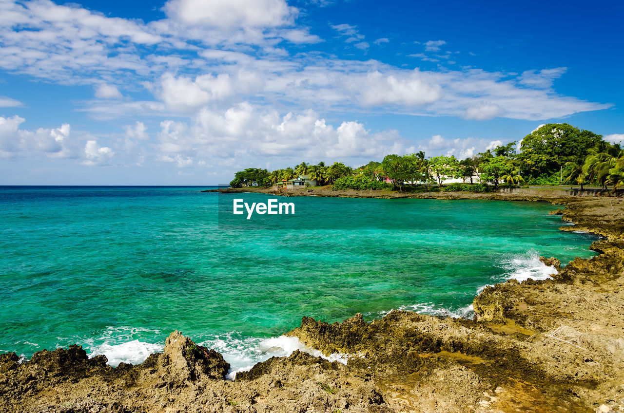 Scenic view of caribbean sea against cloudy sky