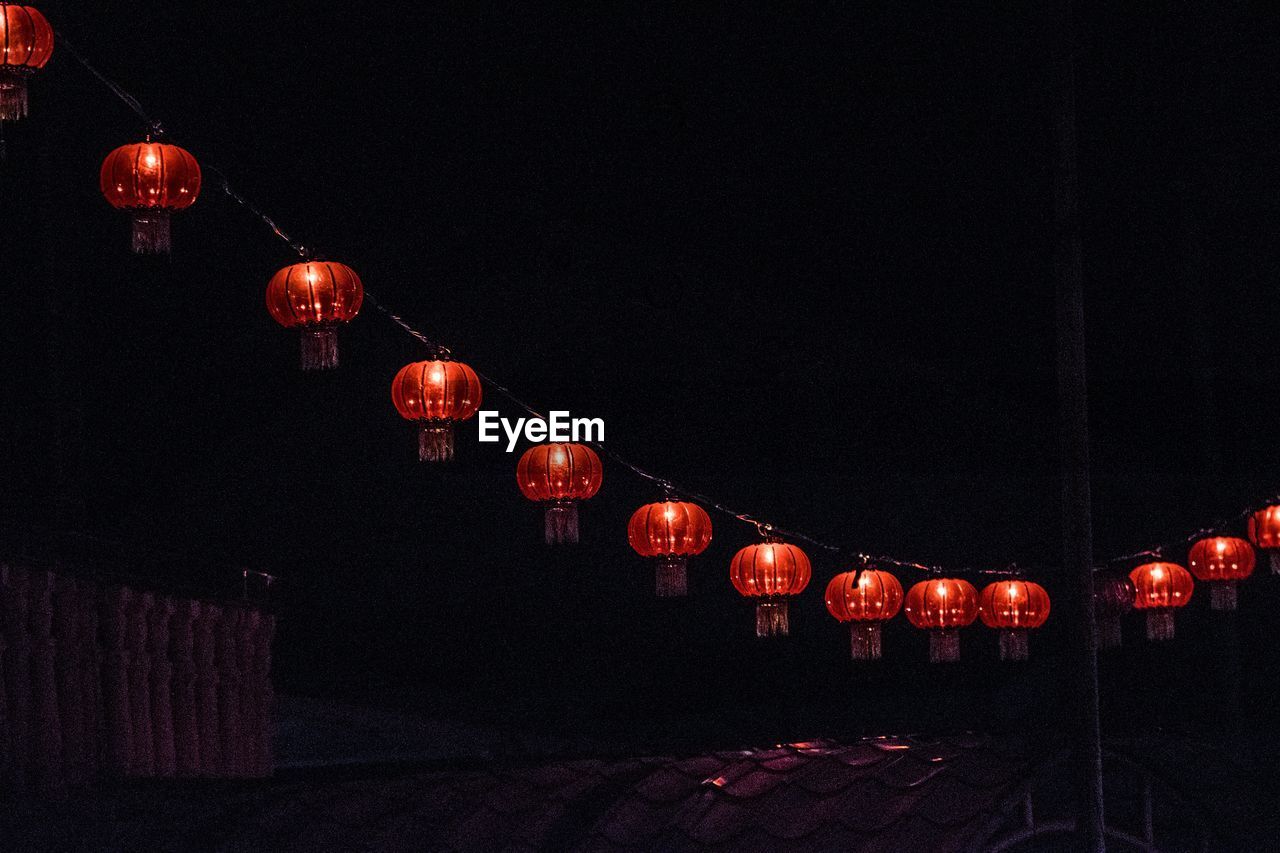 Illuminated lanterns hanging at night