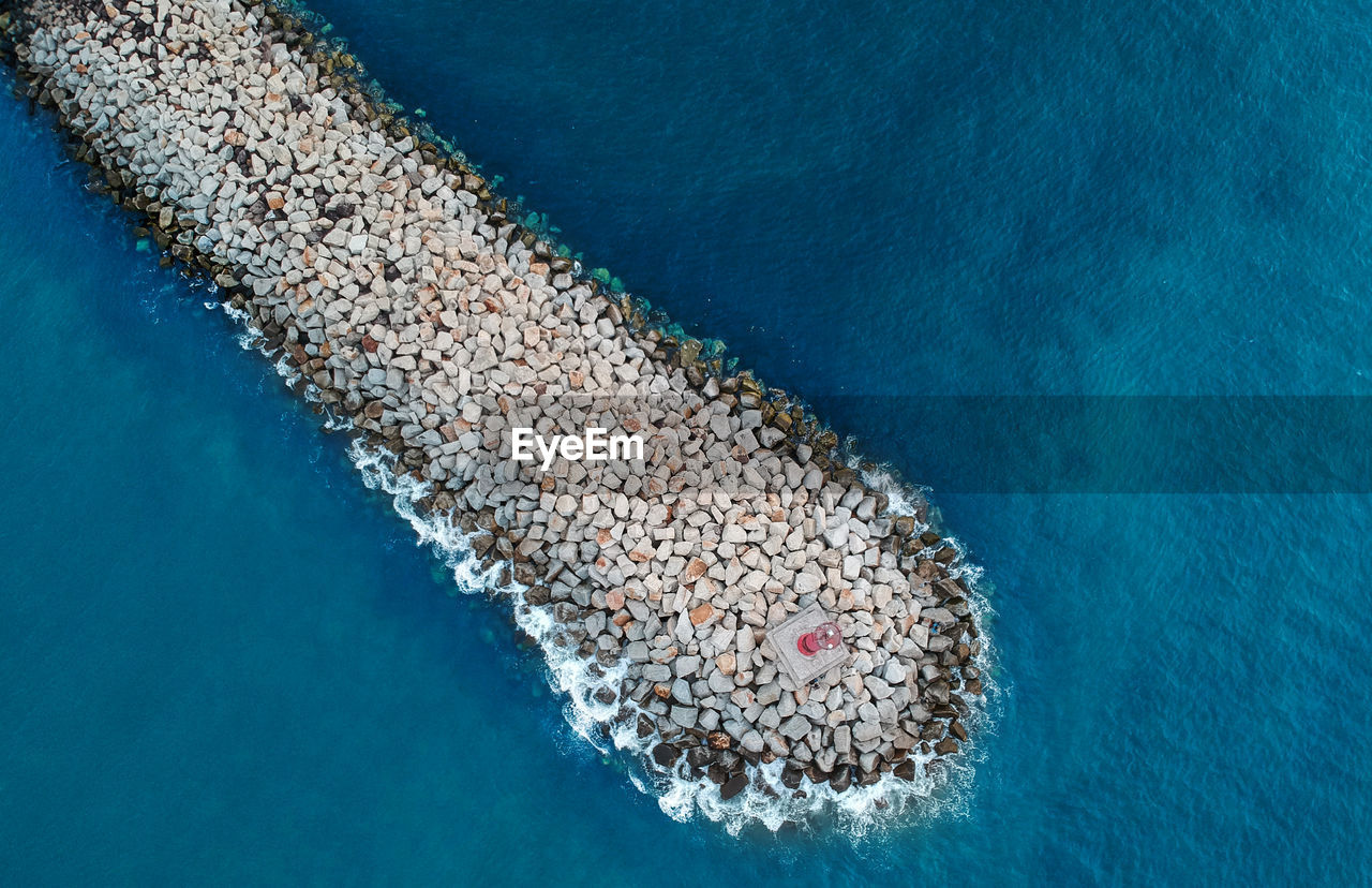 HIGH ANGLE VIEW OF SWIMMING POOL AT SEA