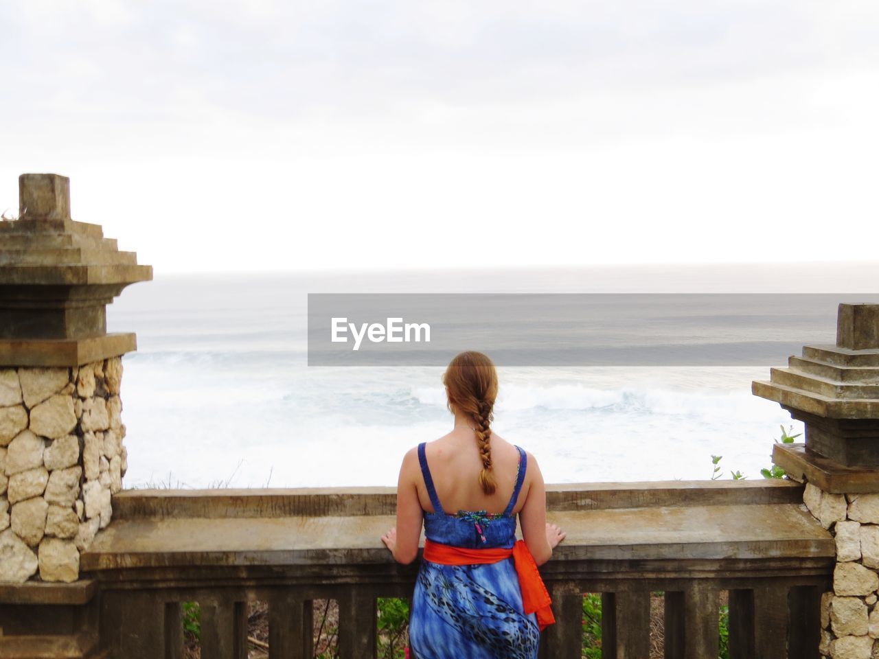 Rear view of woman looking at sea against sky