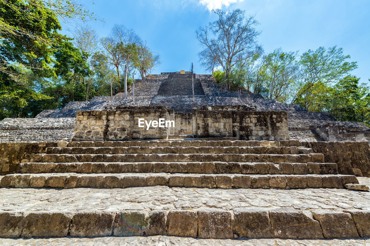 Low angle view of mayan temple ruins at calakmul on sunny day