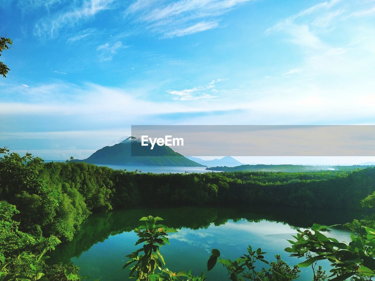 Scenic view of lake and mountains against sky