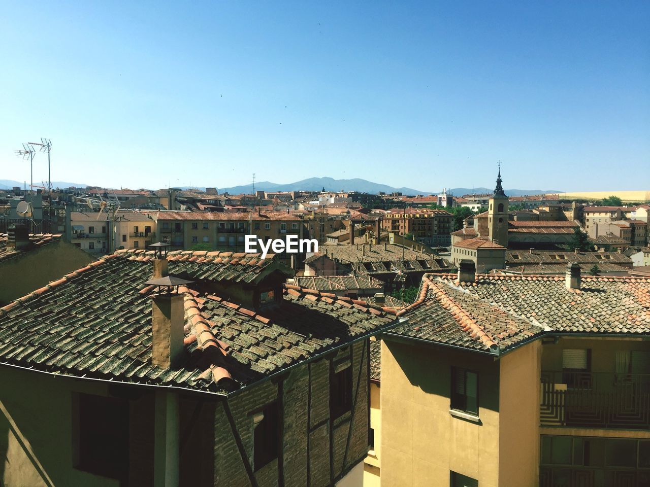 Cityscape against clear blue sky