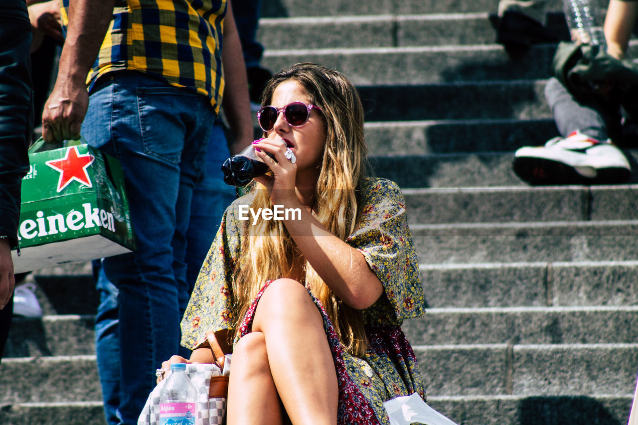 WOMEN SITTING IN SUNGLASSES