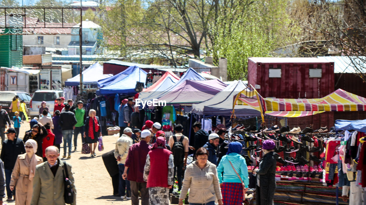 GROUP OF PEOPLE IN MARKET STALL