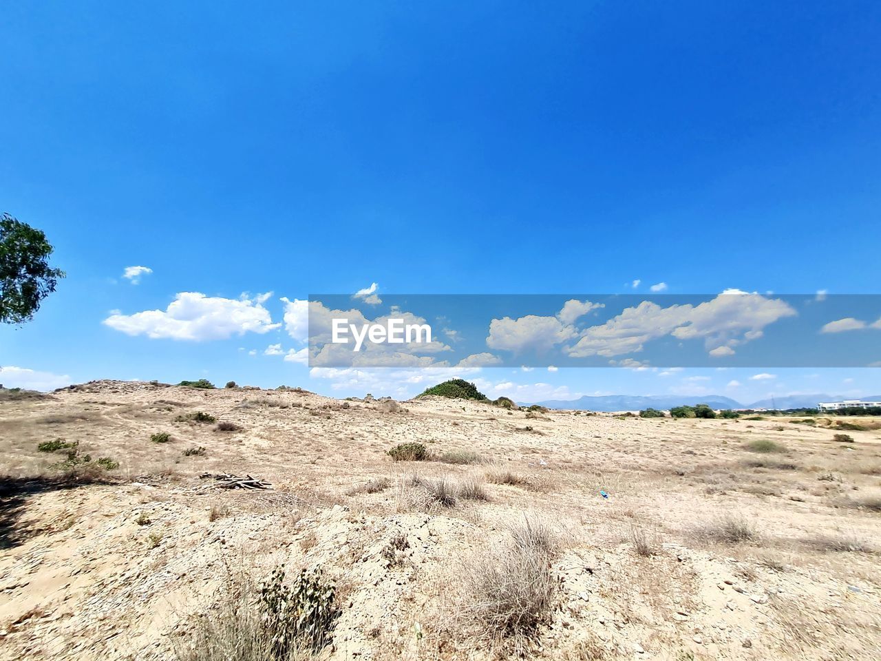 SCENIC VIEW OF LANDSCAPE AGAINST BLUE SKY