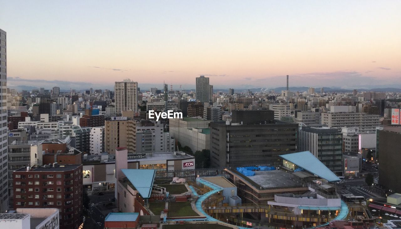 Cityscape against clear sky during sunset