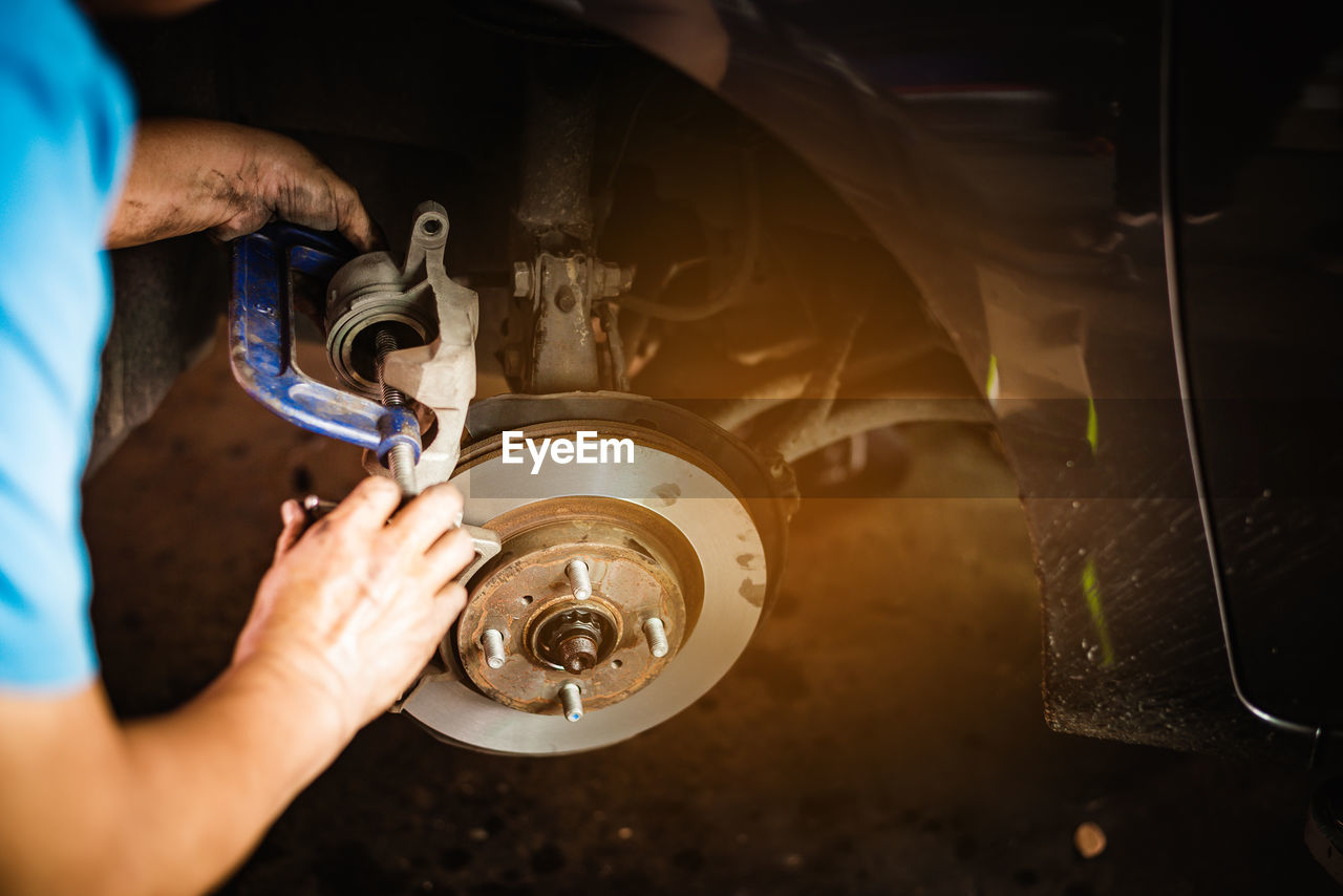 Midsection of man working on car